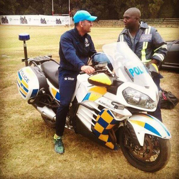 Dhoni rides a bike in Zimbabwe